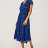 Woman wearing a blue floral dress on a white background