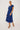 Woman wearing a blue floral dress on a white background
