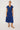 Woman wearing a blue floral dress on a white background