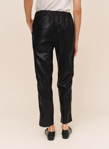 Back view of Bella Dahl black faux leather pull-on trousers showing the gathered elastic waistband, smooth back and relaxed straight-leg silhouette.