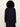 A person shown from the back wearing a dark navy long-sleeve knit top and dark blue jeans against a plain off-white background.