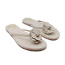 Pair of tan valentina flip-flops with floral designs on a white background
